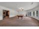 Large game room with pool table, French doors and neutral carpeting at 535 Waters Way, Fayetteville, GA 30215