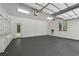 Clean two-car garage with epoxy flooring, built-in storage cabinets and shelving at 535 Waters Way, Fayetteville, GA 30215