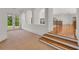 Hallway featuring neutral carpet, wooden stairs, wrought iron railing, and french doors to a balcony at 535 Waters Way, Fayetteville, GA 30215