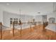 Bright hallway with wood floors, iron and wood banisters, and decorative chandeliers at 535 Waters Way, Fayetteville, GA 30215