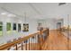 Bright hallway with wood floors, iron and wood banisters, and a decorative chandelier at 535 Waters Way, Fayetteville, GA 30215