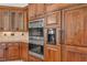 Gourmet kitchen featuring custom wood cabinetry, double ovens, and built-in refrigerator at 535 Waters Way, Fayetteville, GA 30215