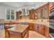 Well-equipped kitchen with custom cabinets, center island, stainless steel appliances, and granite countertops at 535 Waters Way, Fayetteville, GA 30215