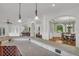 Open layout with a large kitchen island, granite countertops, and view into dining room at 535 Waters Way, Fayetteville, GA 30215