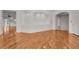 Open living space featuring hardwood floors, recessed lighting, and arched design elements at 535 Waters Way, Fayetteville, GA 30215