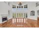 Spacious living room with a fireplace, hardwood floors, and tall windows offering scenic views at 535 Waters Way, Fayetteville, GA 30215