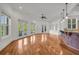 Open-concept living area featuring hardwood floors, French doors to patio, and wet bar with granite countertop at 535 Waters Way, Fayetteville, GA 30215