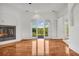 Living room featuring a modern fireplace, hardwood floors, and french doors to an outdoor space at 535 Waters Way, Fayetteville, GA 30215