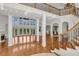 Bright living room featuring hardwood floors, large windows, fireplace, and elegant staircase with iron railings at 535 Waters Way, Fayetteville, GA 30215