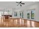 Bright living room with hardwood floors, multiple french doors with lake views and breakfast bar at 535 Waters Way, Fayetteville, GA 30215