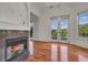 Bright living room with a fireplace, hardwood floors, and backyard views at 535 Waters Way, Fayetteville, GA 30215