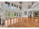 Bright living room with wood floors, fireplace, wall of windows, and access to the dining room at 535 Waters Way, Fayetteville, GA 30215