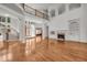 Spacious living room with hardwood floors, fireplace, large windows, and staircase to upper level at 535 Waters Way, Fayetteville, GA 30215