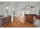 Spacious living room featuring hardwood floors and custom wet bar with granite countertop at 535 Waters Way, Fayetteville, GA 30215