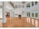 Grand living room boasting soaring ceilings, a fireplace, hardwood floors, and large windows for abundant light at 535 Waters Way, Fayetteville, GA 30215