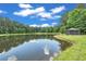 A tranquil pond view with clear water reflecting the sky and trees at 535 Waters Way, Fayetteville, GA 30215