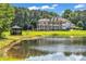 Scenic view of a pond and gazebo with a large home in the background at 535 Waters Way, Fayetteville, GA 30215