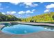 Inviting in-ground pool and spa with a stone waterfall feature and landscaped surroundings at 535 Waters Way, Fayetteville, GA 30215