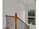 Staircase with wood and iron banister and a large arched window providing lots of natural light at 535 Waters Way, Fayetteville, GA 30215