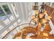 Dramatic staircase illuminated by a chandelier and surrounded by large windows, offering a stunning view at 535 Waters Way, Fayetteville, GA 30215