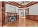 Home office with a fireplace, wood paneled walls, and hardwood flooring at 535 Waters Way, Fayetteville, GA 30215