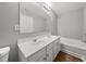Bathroom with double vanity, tub, and gray walls at 747 Crestwell Sw Cir, Atlanta, GA 30331
