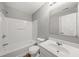 Bathroom featuring a shower-tub combo with a large mirror and a single sink vanity at 747 Crestwell Sw Cir, Atlanta, GA 30331