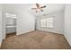 Bright bedroom with a ceiling fan, a window, and access to an attached bathroom at 747 Crestwell Sw Cir, Atlanta, GA 30331