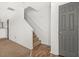 Bright hallway with hardwood flooring and carpeted stairs, leading to the upper level of the home at 747 Crestwell Sw Cir, Atlanta, GA 30331