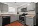 Well-lit kitchen features gray cabinetry, stainless steel appliances, and a window over the sink at 747 Crestwell Sw Cir, Atlanta, GA 30331