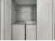 Enclosed laundry room with white washer and dryer at 747 Crestwell Sw Cir, Atlanta, GA 30331