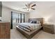 Relaxing bedroom with a ceiling fan, large window and comfortable king sized bed at 1310 Speckle Park Way, Stockbridge, GA 30281