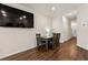 Dining room with wood floors, table with seating for four, and a mounted television at 1310 Speckle Park Way, Stockbridge, GA 30281
