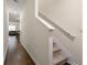 Bright hallway with wooden floors leading to the staircase and open living area at 1310 Speckle Park Way, Stockbridge, GA 30281