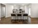 Modern kitchen with granite countertops, stainless steel appliances, and a breakfast bar at 1310 Speckle Park Way, Stockbridge, GA 30281