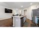 Open kitchen featuring granite countertops, stainless steel appliances, and a view of the dining area at 1310 Speckle Park Way, Stockbridge, GA 30281