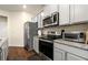 Kitchen showcasing stainless steel appliances, granite countertops, and ample cabinet space at 1310 Speckle Park Way, Stockbridge, GA 30281