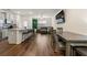 Open-concept living area showcasing a modern kitchen, granite counters and a cozy living space at 1310 Speckle Park Way, Stockbridge, GA 30281