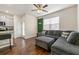 Open-concept living area with access to the kitchen, a gray sectional sofa, and natural light at 1310 Speckle Park Way, Stockbridge, GA 30281