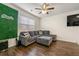 Comfortable living room featuring a plush gray sofa and an accent wall at 1310 Speckle Park Way, Stockbridge, GA 30281