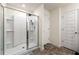 Bathroom features a tile shower with glass door and white shelving at 1310 Speckle Park Way, Stockbridge, GA 30281