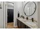 Bathroom featuring double sinks, granite countertops, modern fixtures, and round mirror at 1720 Little Willeo Rd, Marietta, GA 30068