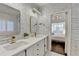 Bathroom featuring double sinks with white cabinets, gold fixtures, and subway tiles at 3355 Olivia Ct, Cumming, GA 30041