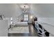 Bedroom with a geometric light fixture, wood floors, and minimalist decor at 3355 Olivia Ct, Cumming, GA 30041