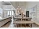 Bright dining room with a large table, a modern lighting fixture, and floor to ceiling windows at 3355 Olivia Ct, Cumming, GA 30041