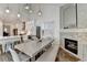 Stylish dining area showcasing a fireplace, wood floors, and direct access to the modern kitchen at 3355 Olivia Ct, Cumming, GA 30041