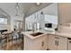 Modern kitchen boasts white cabinets, stainless steel sink and fixtures, with an adjacent breakfast area and hardwood flooring at 3355 Olivia Ct, Cumming, GA 30041