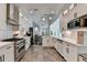 Modern kitchen featuring white cabinets, stainless steel appliances, and a subway tile backsplash at 3355 Olivia Ct, Cumming, GA 30041