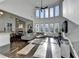A spacious open living room with a wall of windows, wood floors, and modern furnishings at 3355 Olivia Ct, Cumming, GA 30041