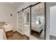 Stunning main bedroom featuring a barn door to the ensuite bathroom and a glimpse of the bed in the mirror at 3355 Olivia Ct, Cumming, GA 30041